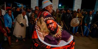 A woman wearing a cloth with face of King Misuzulu KaZwelithini